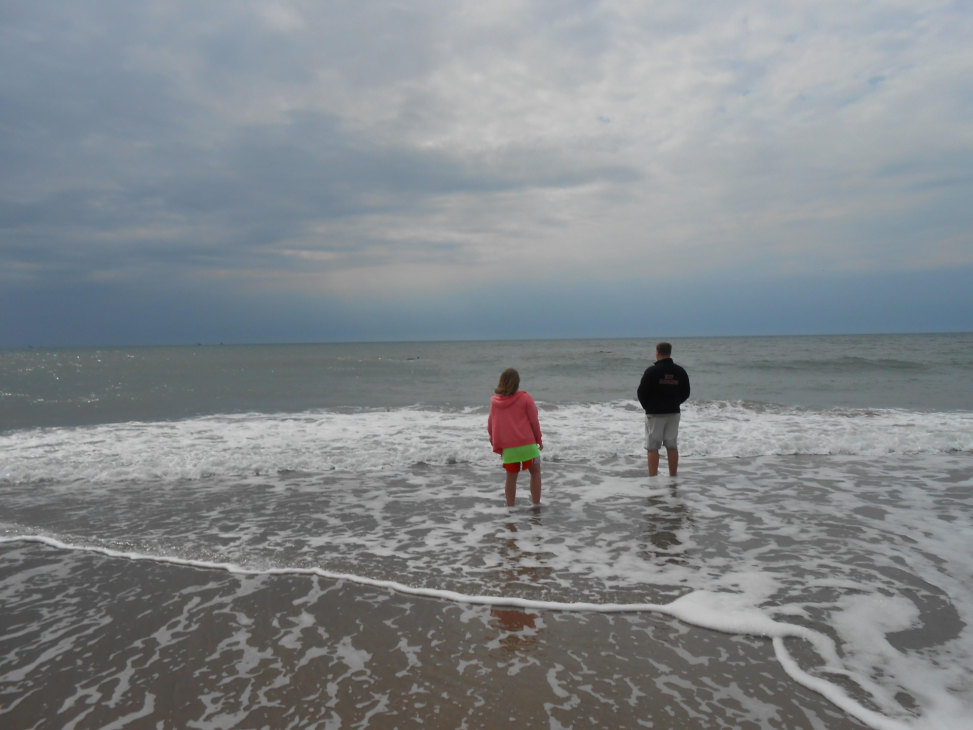 Couple walking on Grayland Beach at golden hour