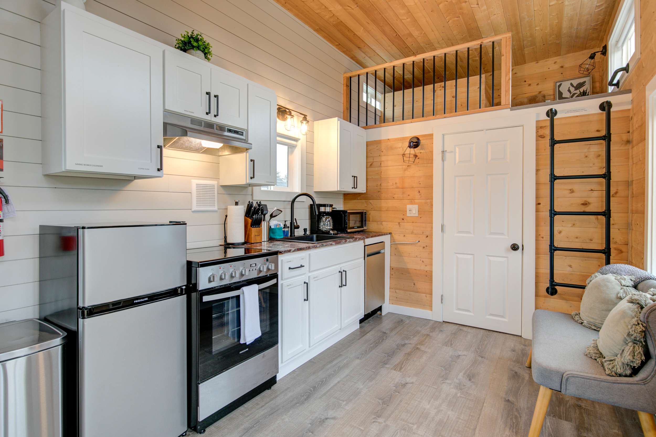 Cottage 11 interior — modern tiny house kitchen with loft