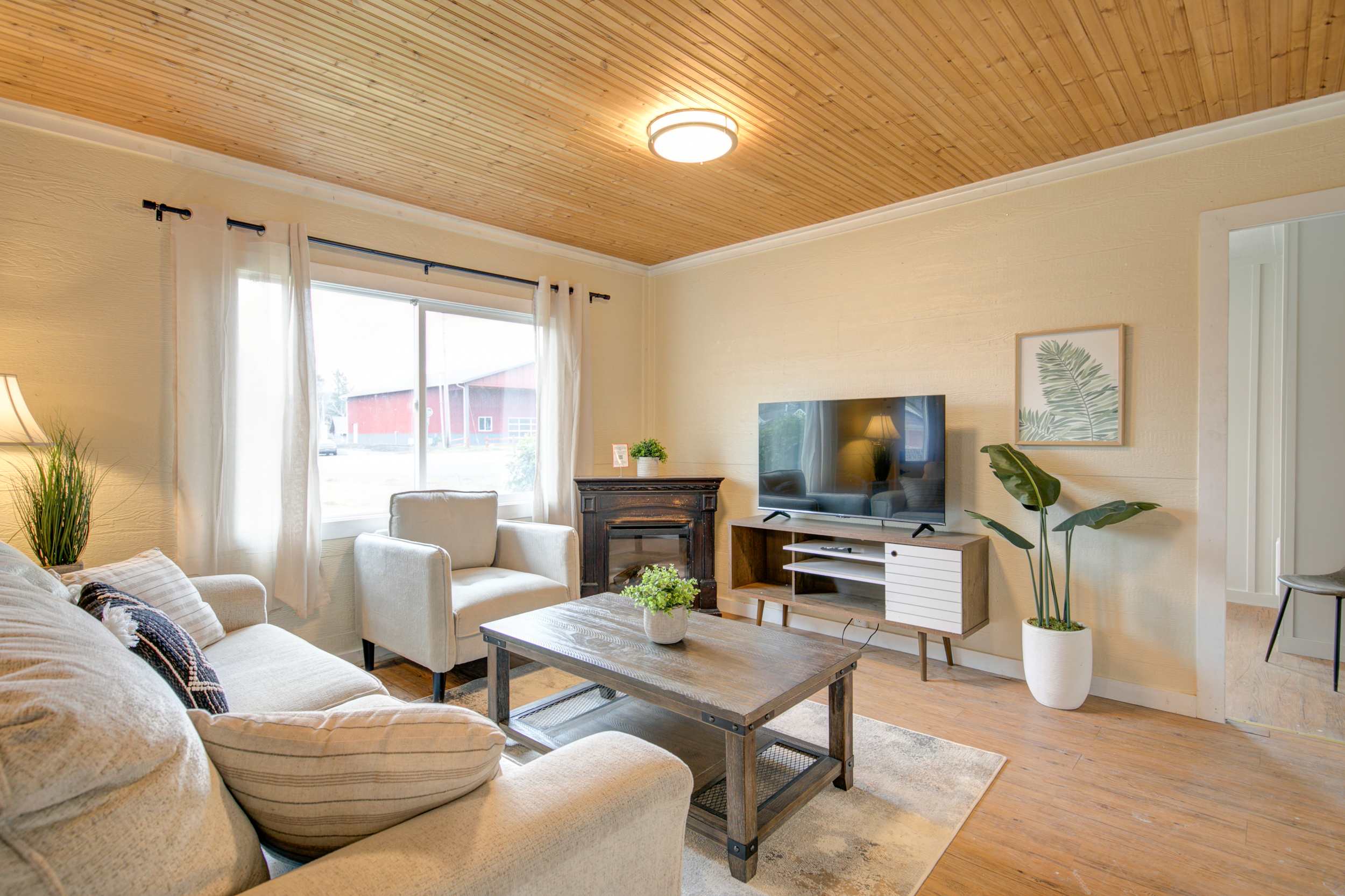 Cottage 12 living room with vaulted wood ceiling and electric fireplace