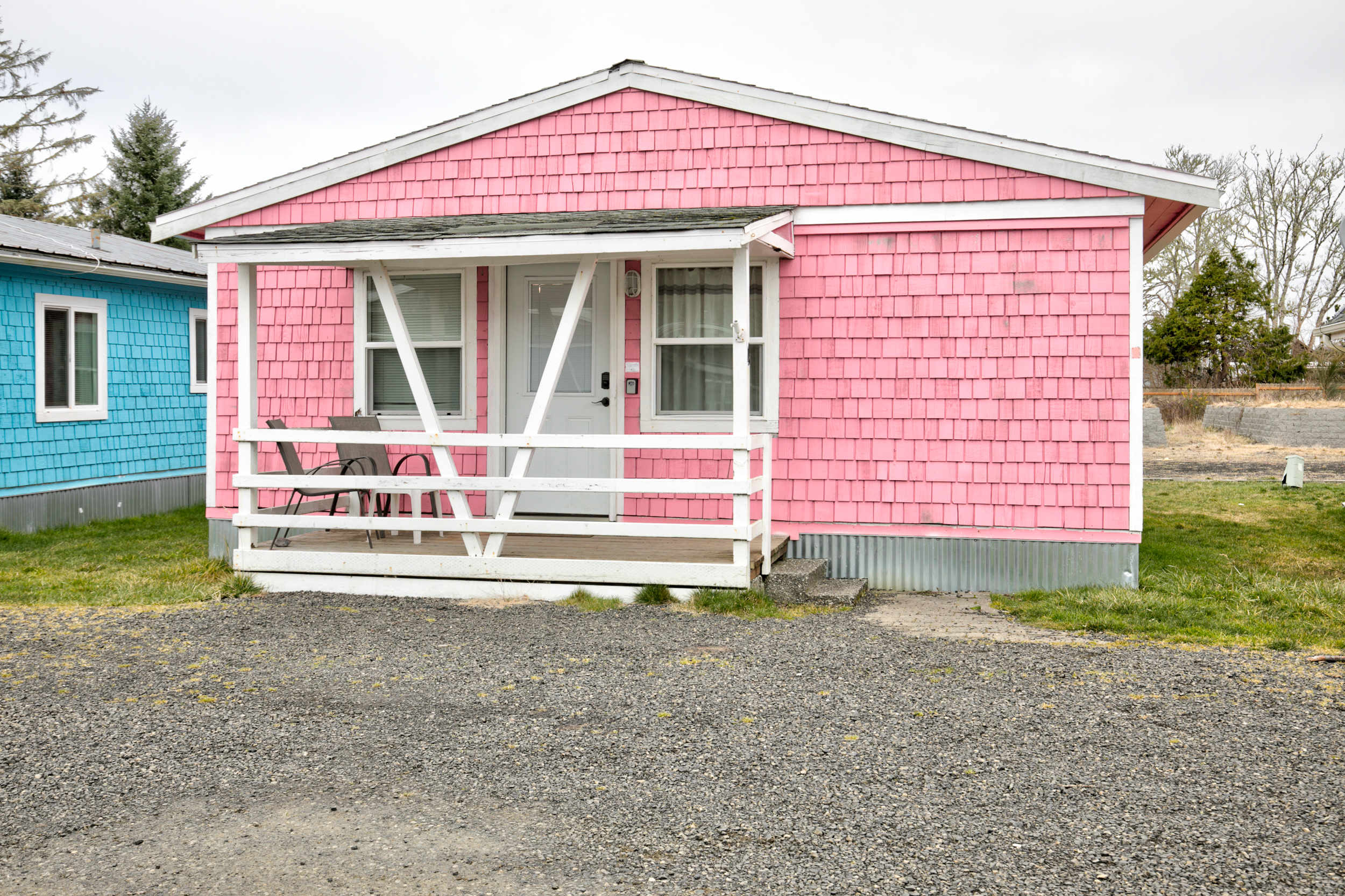 Cottage 4 exterior — pink shingle cottage with covered porch