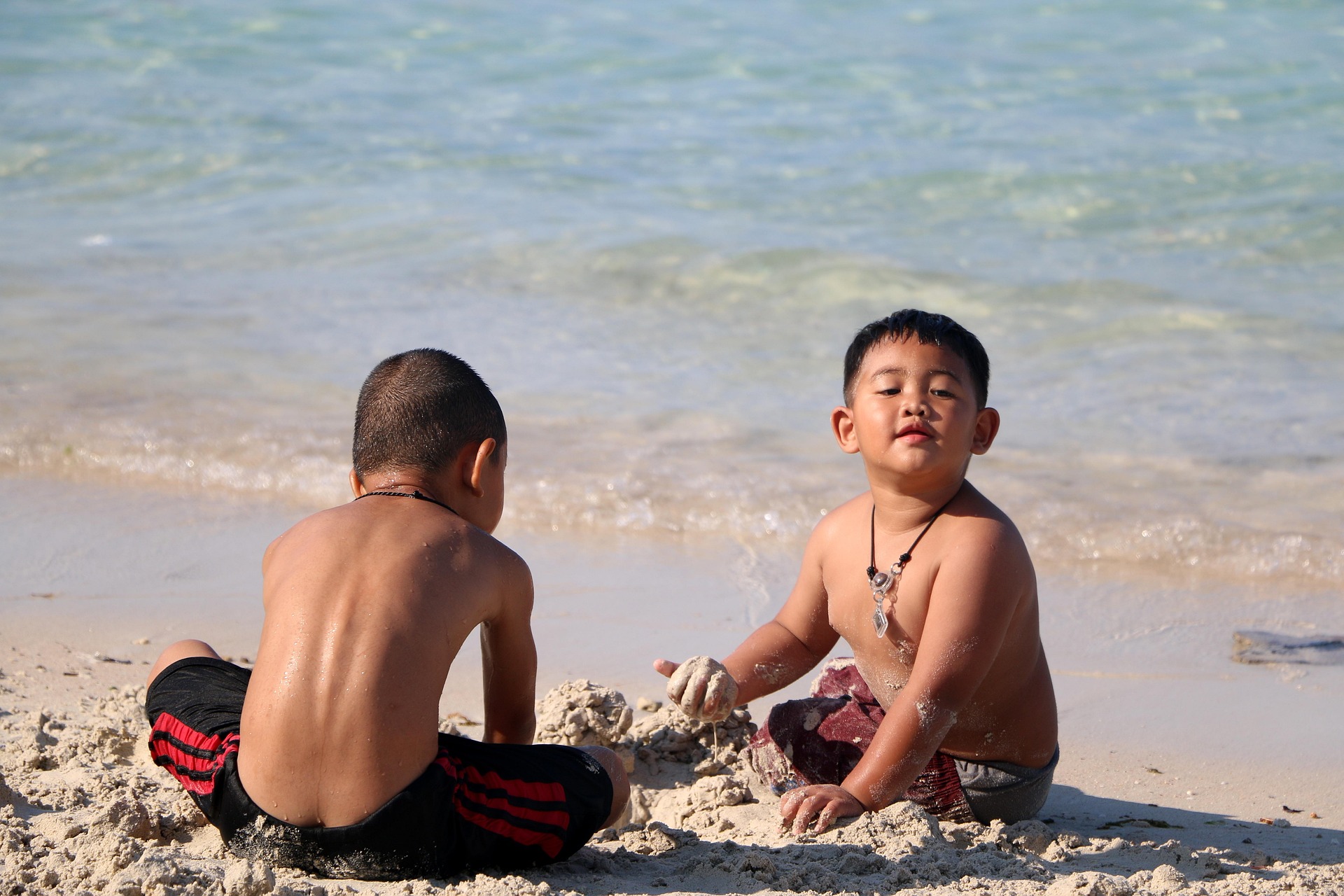 Children playing on the Pacific Ocean shoreline